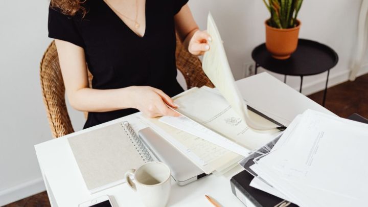 person reading paper at desk