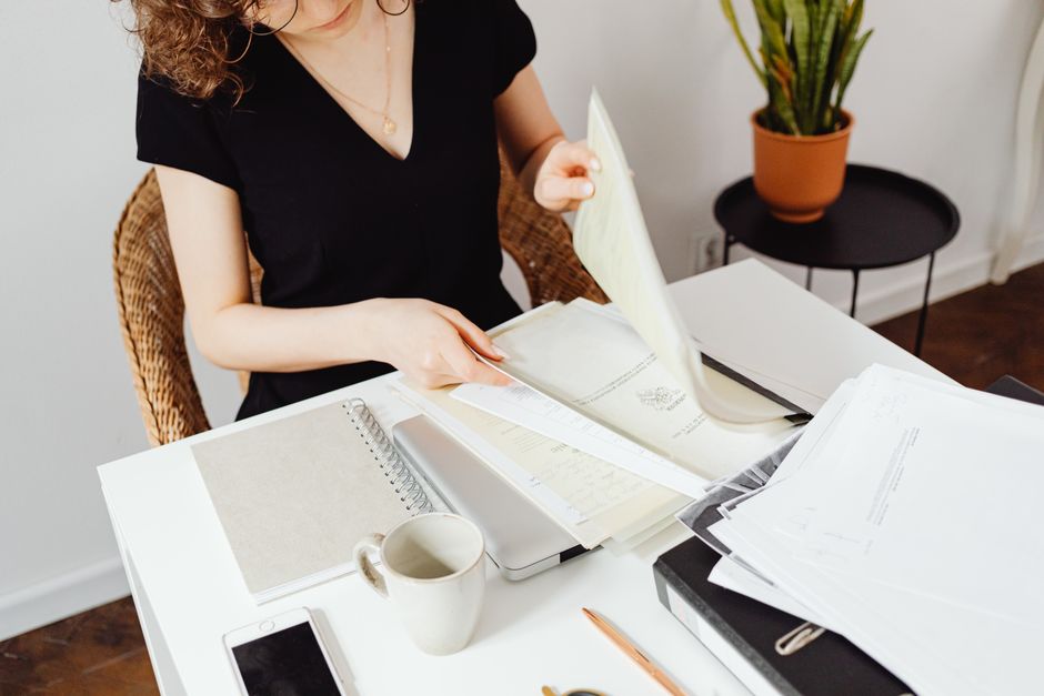 person reading paper at desk