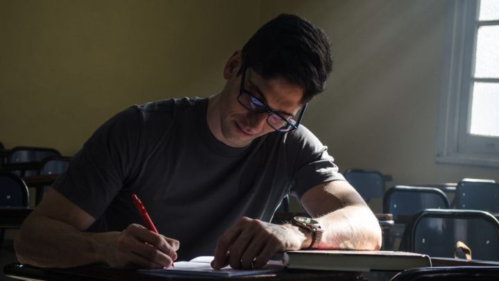 person writing notebook sunlight