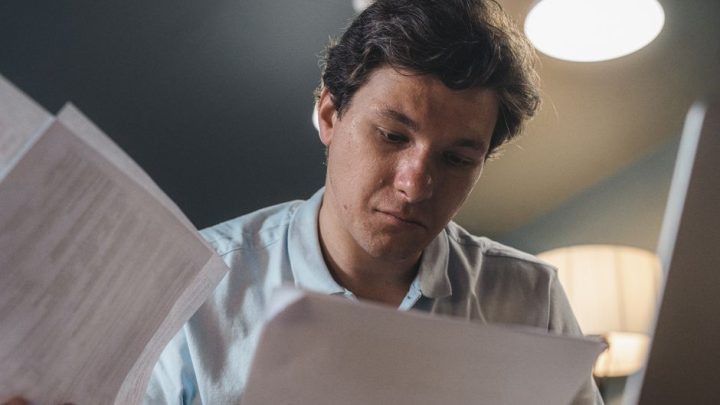 person reading paperwork at home
