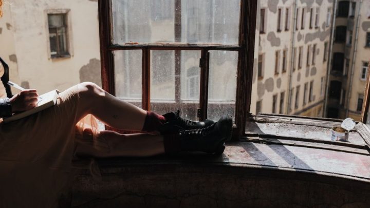 person sitting quietly window