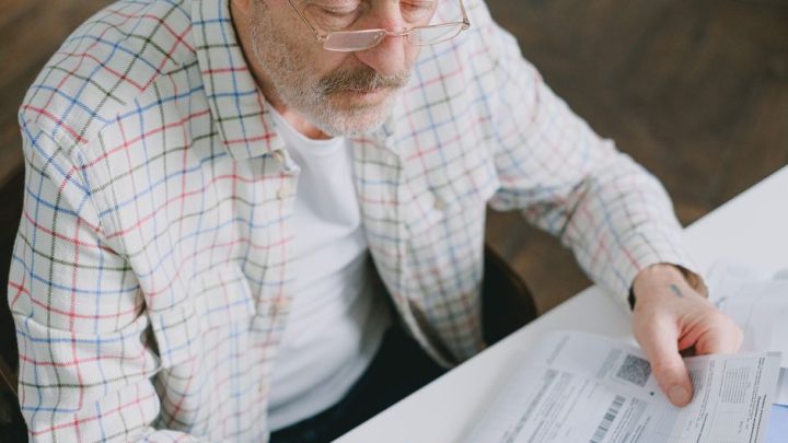 person reading papers at home
